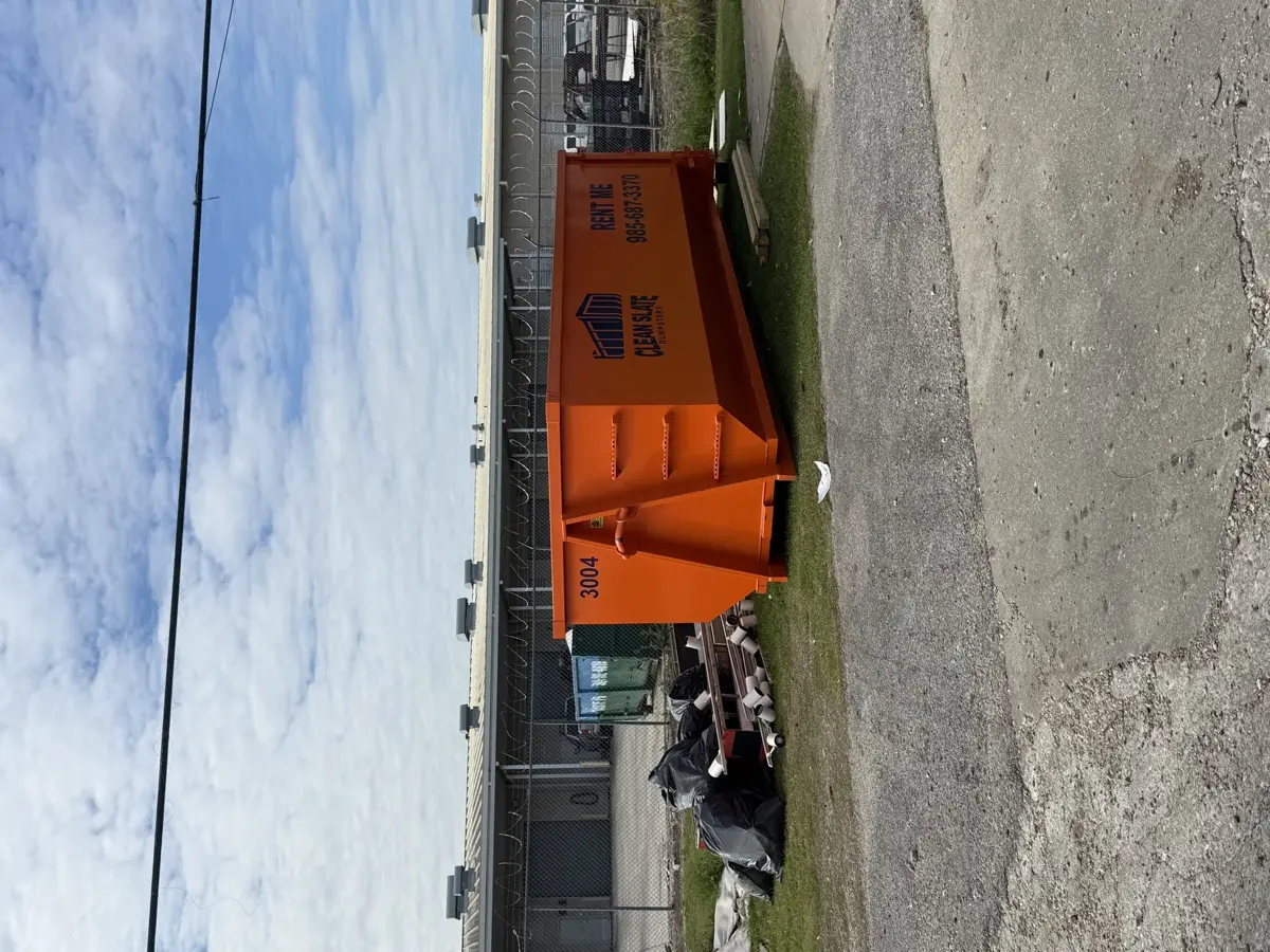 dumpster truck fenced yard delivery